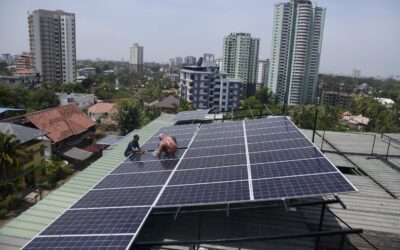 Workers installing solar panels in India - NDC-3 climate targets