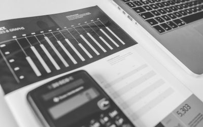 Calculator and printed figures on a desk